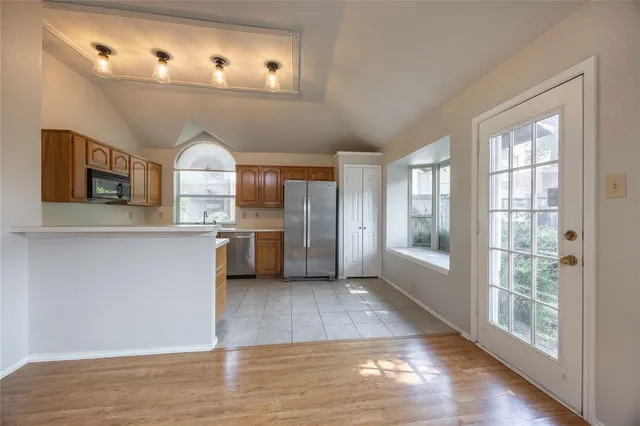 a view of a kitchen with a sink dishwasher and a fireplace