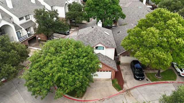an aerial view of a house with outdoor space