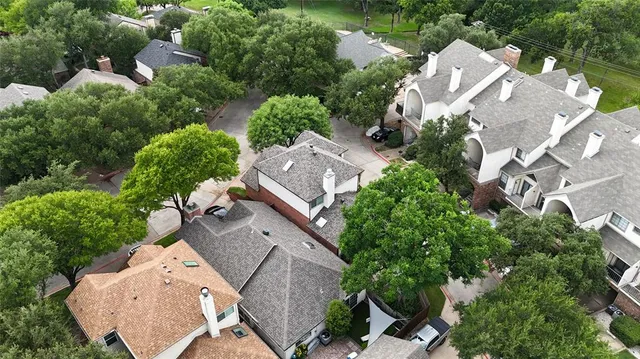 an aerial view of multiple houses with yard