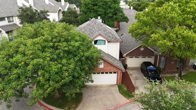 an aerial view of a house with swimming pool and garden