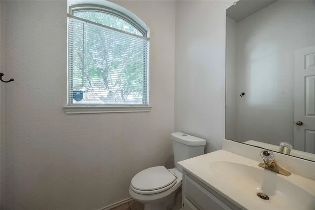 a bathroom with a sink a toilet and a mirror