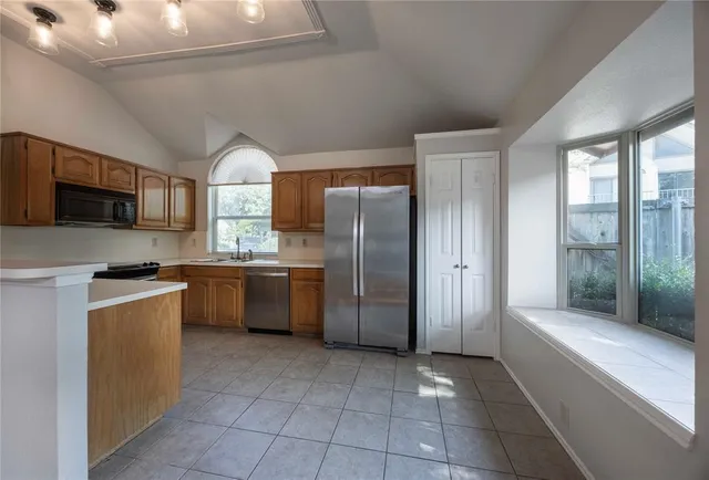 a kitchen with a refrigerator a sink and a stove