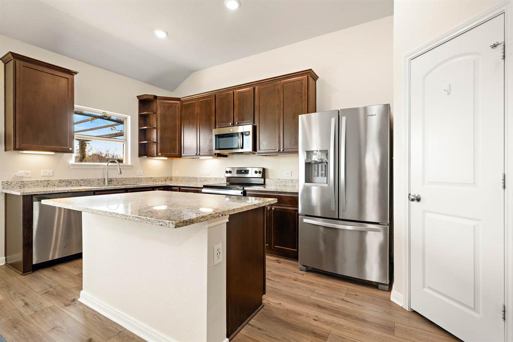 4009 Bravo Ranch Road Waco, TX 76705 - Photo 14 of 34 a kitchen with stainless steel appliances granite countertop a refrigerator stove and sink