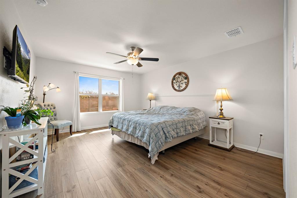 4009 Bravo Ranch Road Waco, TX 76705 - Photo 16 of 34 a bedroom with a bed and wooden floor