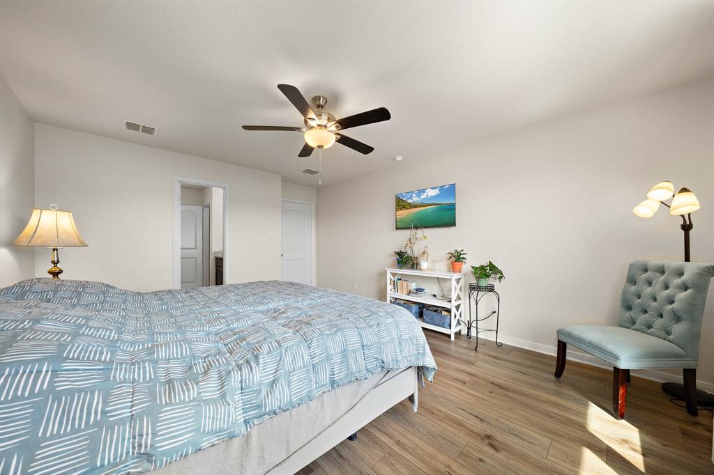 4009 Bravo Ranch Road Waco, TX 76705 - Photo 17 of 34 a bedroom with a bed and a table in it