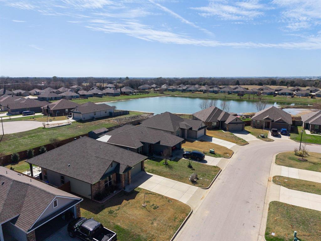 4009 Bravo Ranch Road Waco, TX 76705 - Photo 2 of 34 an aerial view of a house with a garden and lake view