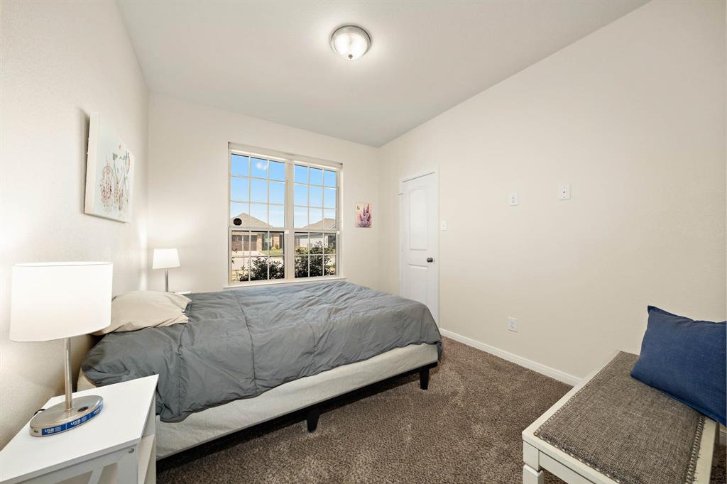 4009 Bravo Ranch Road Waco, TX 76705 - Photo 21 of 34 a bedroom with a bed and a lamp