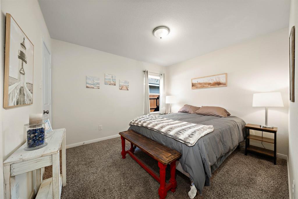 4009 Bravo Ranch Road Waco, TX 76705 - Photo 22 of 34 a bedroom with a bed and a lamp on the dresser