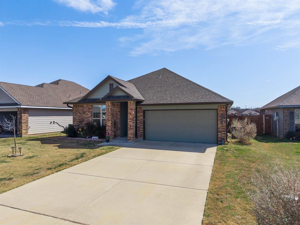 4009 Bravo Ranch Road Waco, TX 76705 - Photo 4 of 34 a front view of a house with a yard and garage