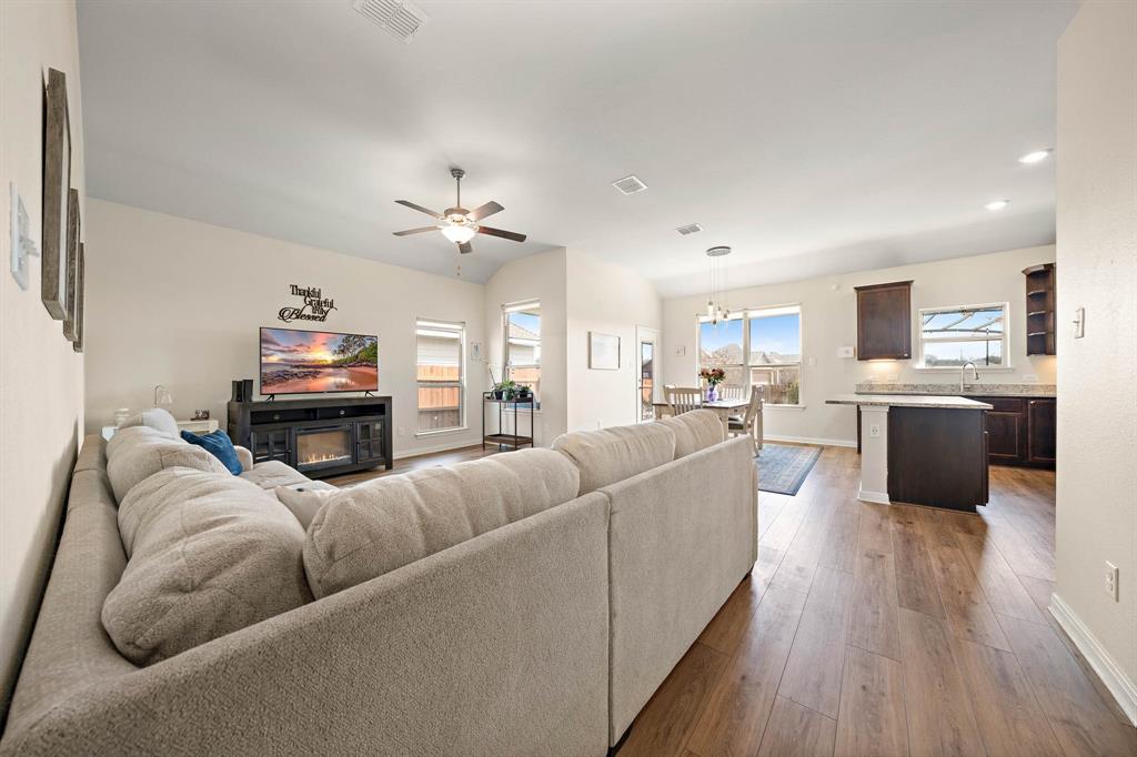 4009 Bravo Ranch Road Waco, TX 76705 - Photo 9 of 34 a living room with furniture kitchen view and a chandelier