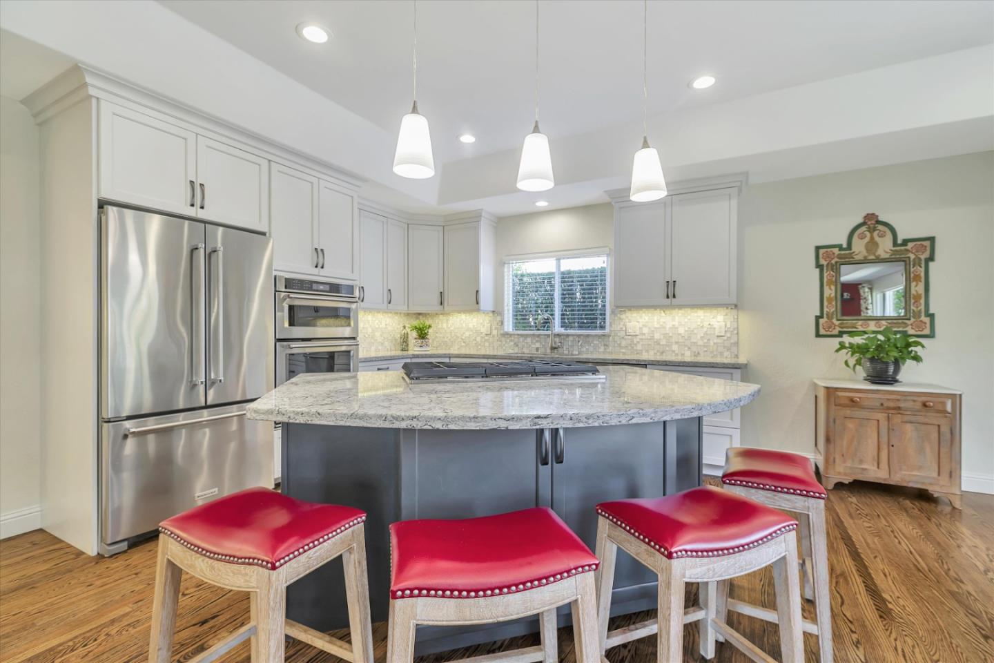 1190 Bruckner Circle Mountain View, CA 94040 - Photo 13 of 51 a kitchen with a dining table chairs refrigerator and wooden floor
