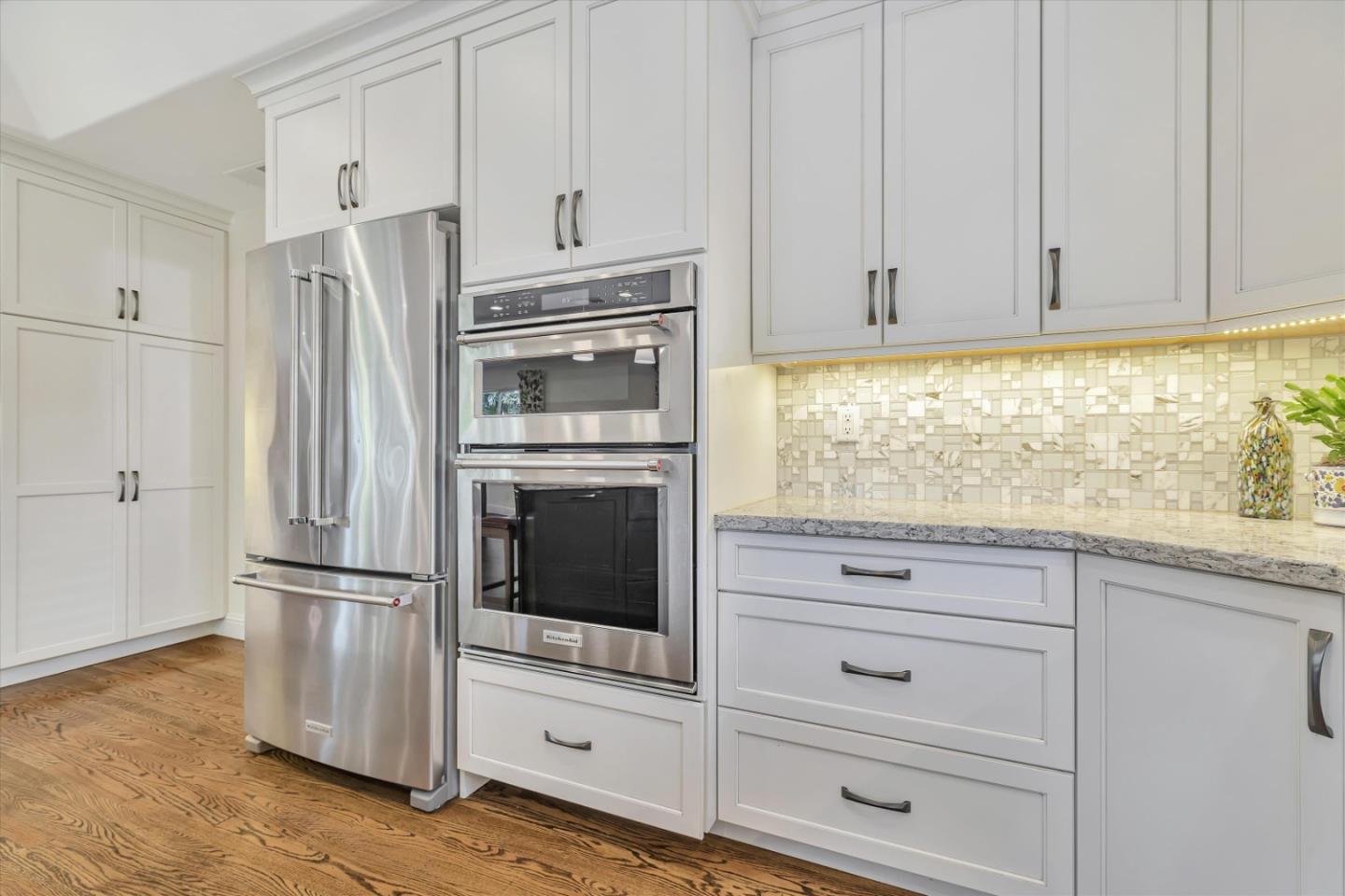 1190 Bruckner Circle Mountain View, CA 94040 - Photo 15 of 51 a kitchen with granite countertop white cabinets and stainless steel appliances