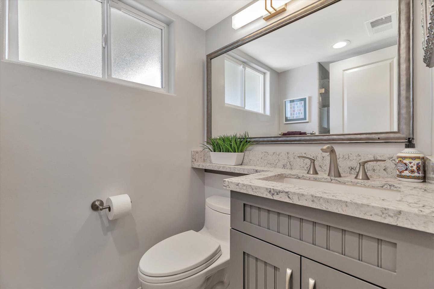 1190 Bruckner Circle Mountain View, CA 94040 - Photo 24 of 51 a bathroom with a granite countertop toilet sink and mirror