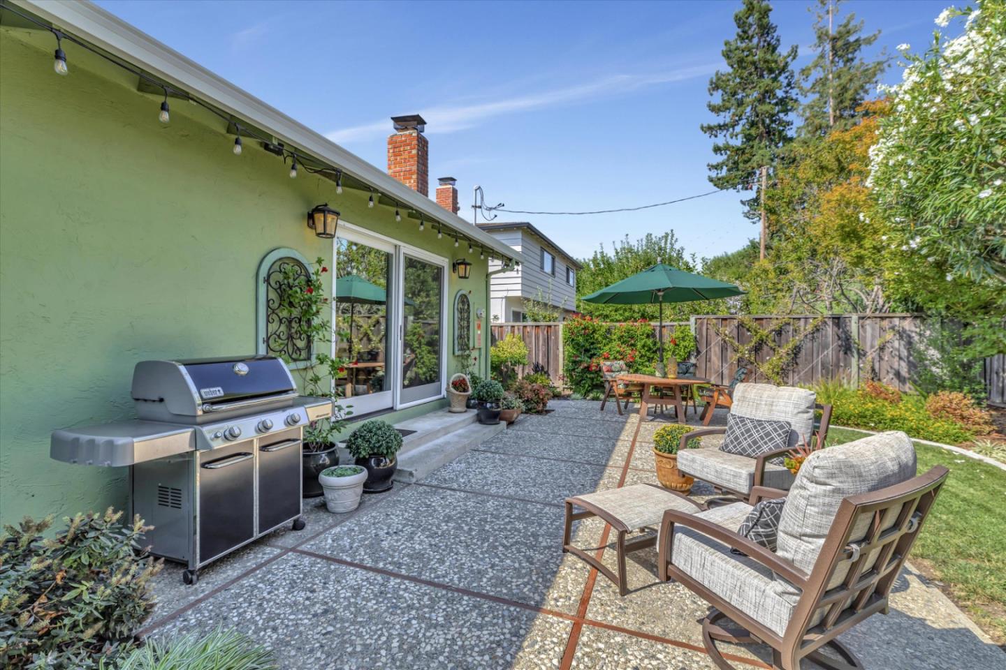1190 Bruckner Circle Mountain View, CA 94040 - Photo 46 of 51 a view of a patio with table and chairs potted plants and a palm tree