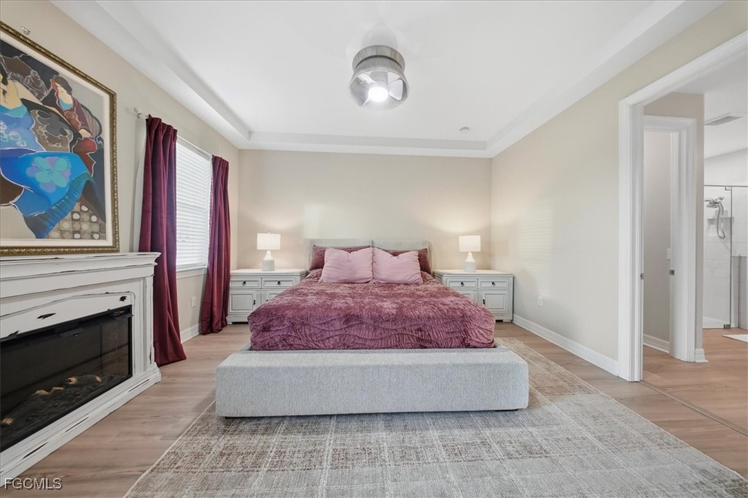 16128 Lotus Way Punta Gorda, FL 33982 - Photo 14 of 49 a spacious bedroom with a bed and a fireplace