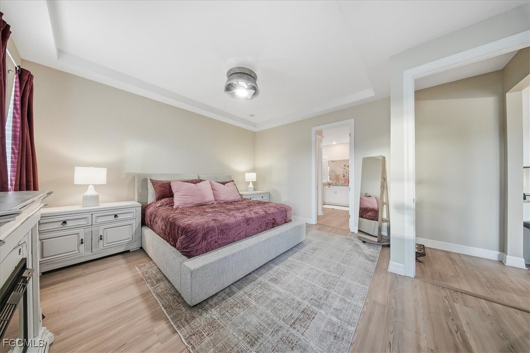 16128 Lotus Way Punta Gorda, FL 33982 - Photo 15 of 49 a spacious bedroom with a large bed and wooden floor