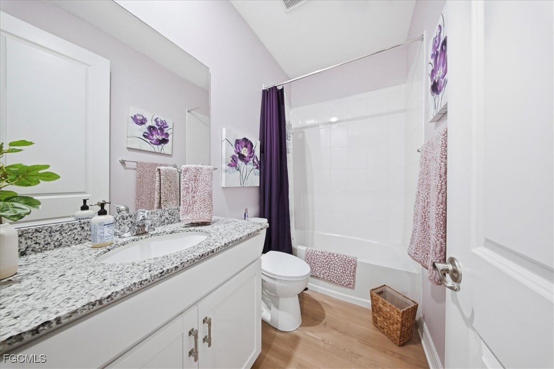 16128 Lotus Way Punta Gorda, FL 33982 - Photo 18 of 49 a bathroom with a granite countertop sink mirror vanity and toilet