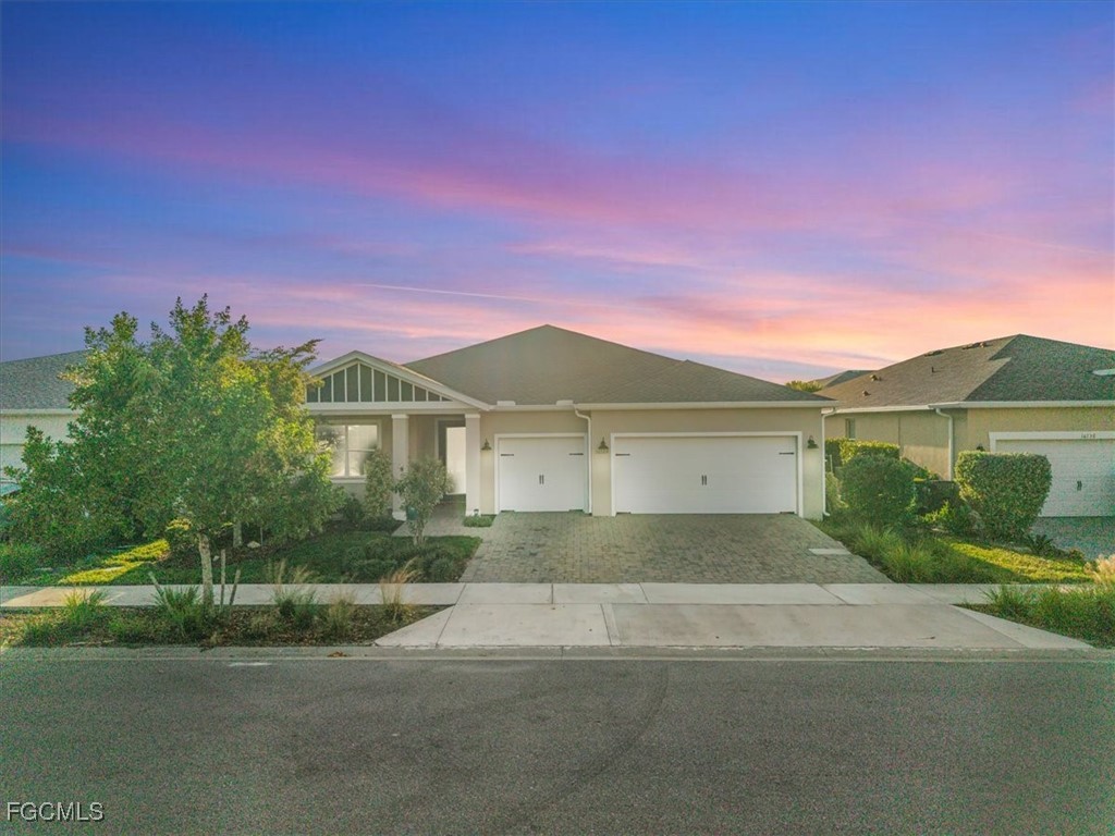 16128 Lotus Way Punta Gorda, FL 33982 - Photo 2 of 49 a front view of a house with a yard and garage