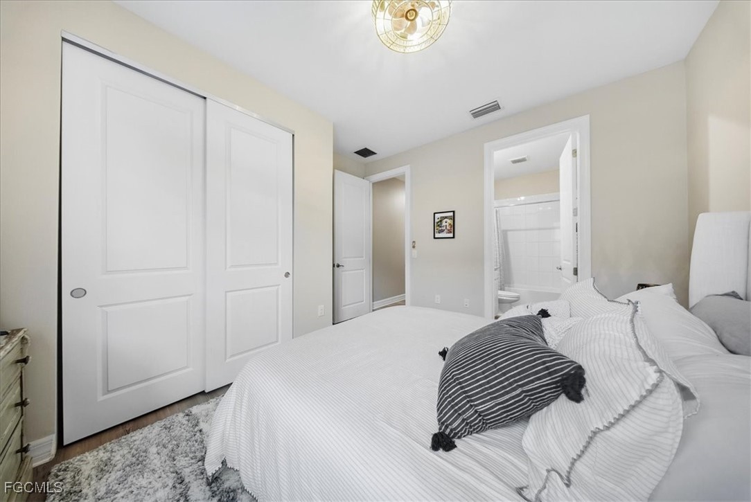 16128 Lotus Way Punta Gorda, FL 33982 - Photo 21 of 49 a bedroom with a white bed and a dresser