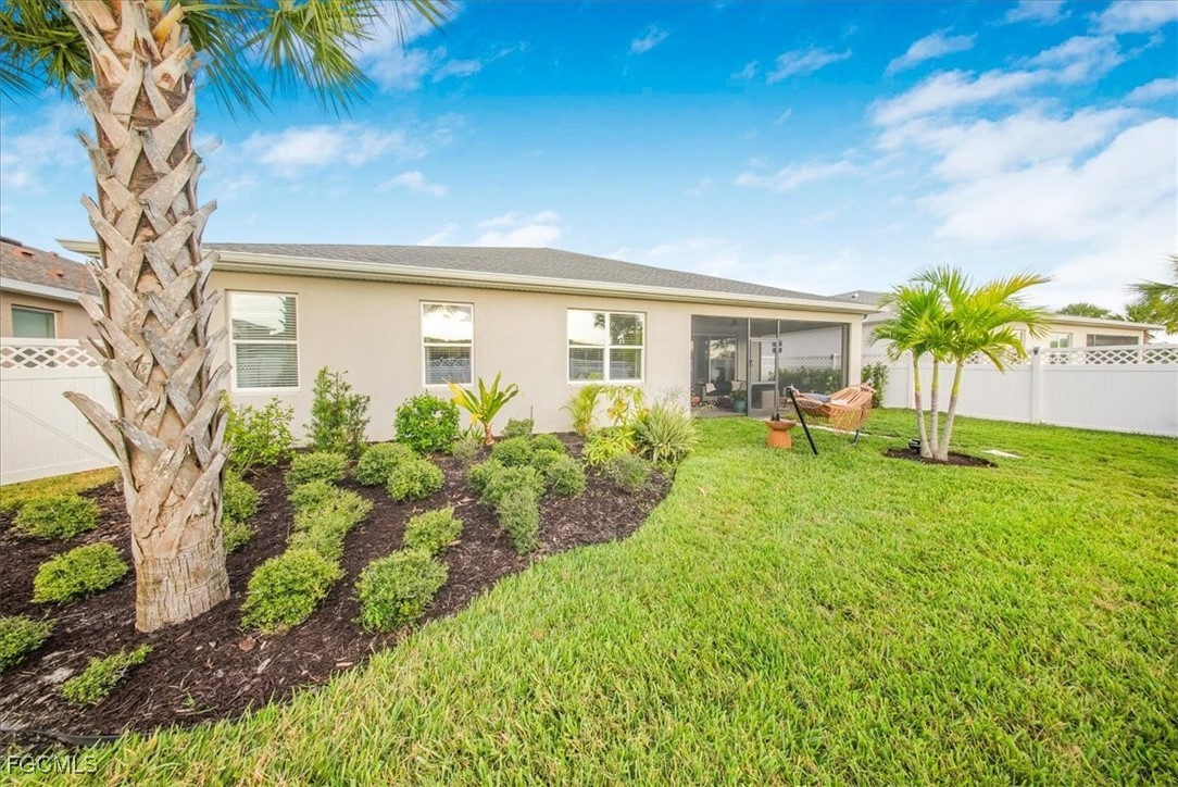 16128 Lotus Way Punta Gorda, FL 33982 - Photo 30 of 49 a view of a house with backyard and a garden