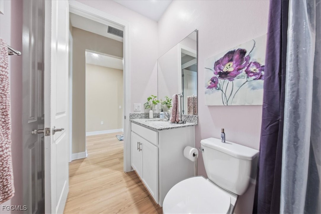 16128 Lotus Way Punta Gorda, FL 33982 - Photo 38 of 49 a bathroom with a granite countertop toilet sink and mirror