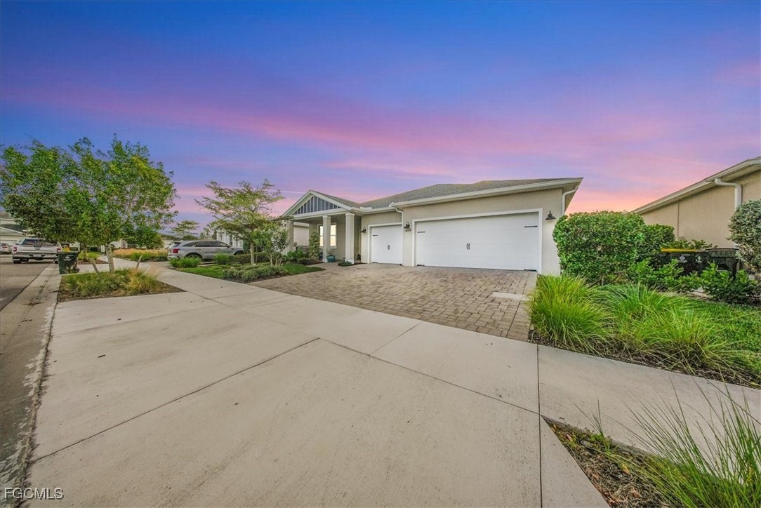 16128 Lotus Way Punta Gorda, FL 33982 - Photo 42 of 49 a front view of a house with a yard and a garage