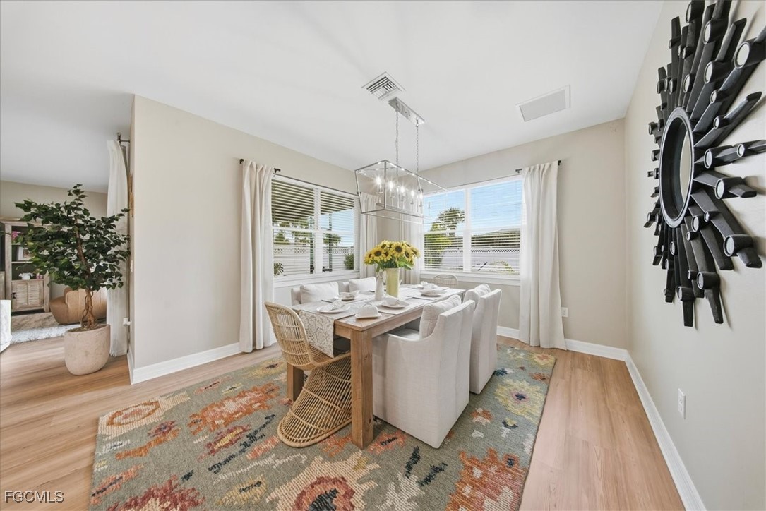 16128 Lotus Way Punta Gorda, FL 33982 - Photo 5 of 49 a view of a dining room with furniture window and wooden floor