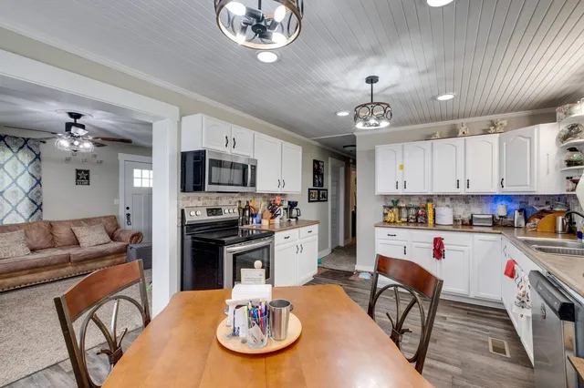 a kitchen with a dining table and chairs