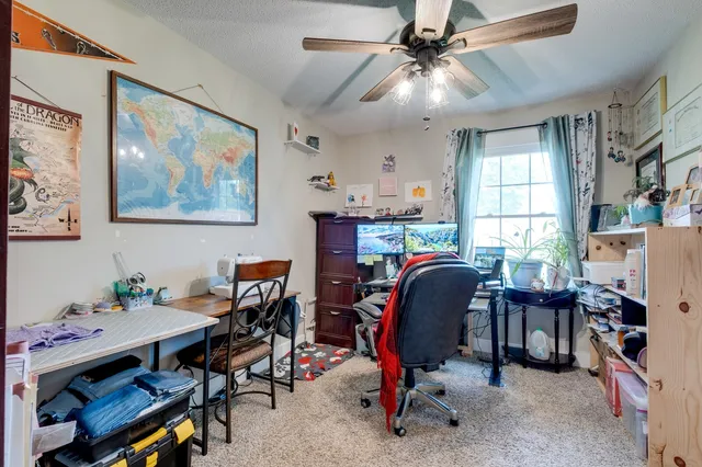 a view of a workspace with furniture and a workspace