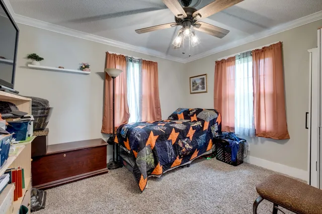 a bed sitting in a bedroom next to a window