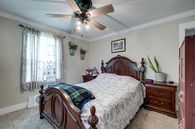 a bedroom with a bed and a chandelier