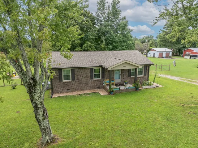 a view of a house with a yard porch and sitting area