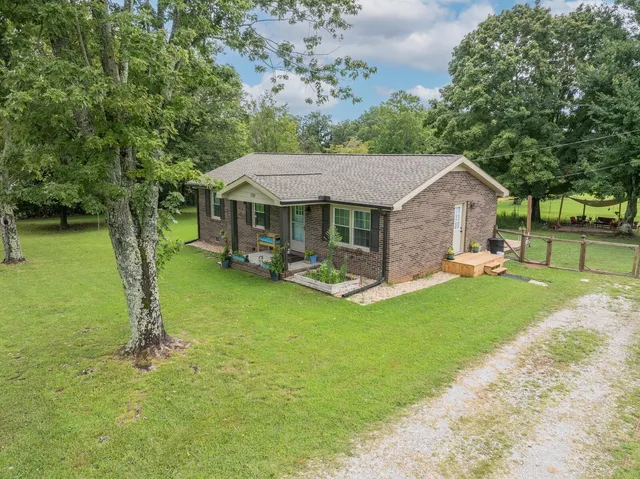 a front view of a house with a yard table and chairs