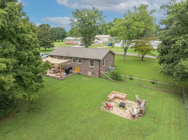 a green field with some trees in the background