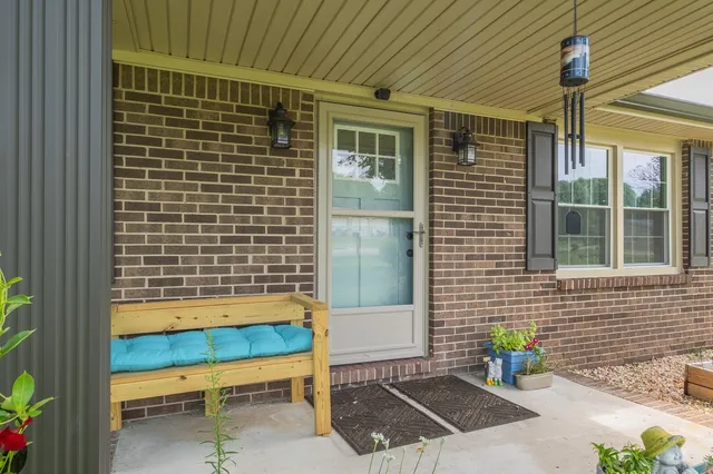 a front view of a house with outdoor seating