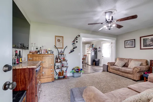 a living room with furniture and a gym equipment