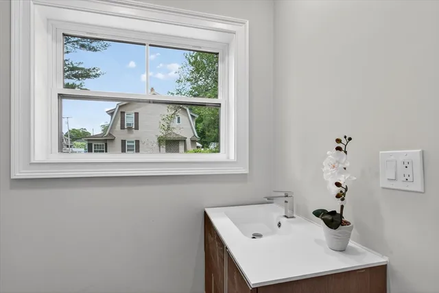 a bathroom with a sink and a window