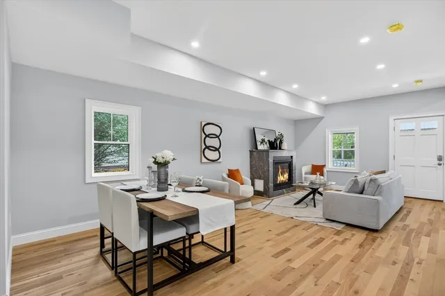 a living room with fireplace furniture and a wooden floor
