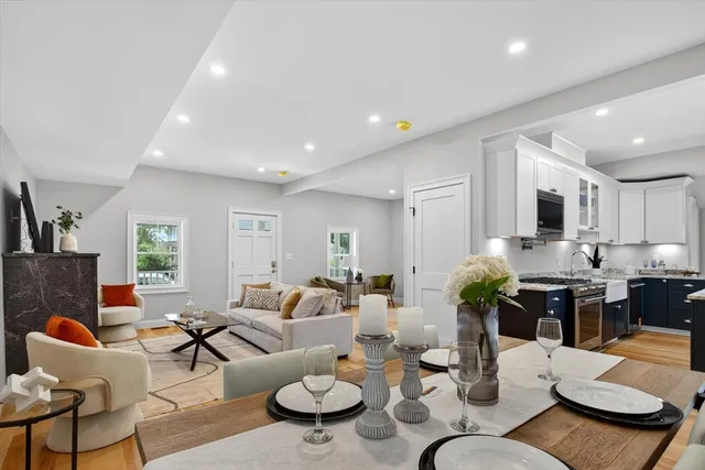 a living room with furniture kitchen view and a window