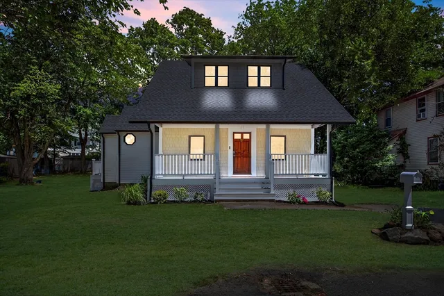 a front view of a house with a garden