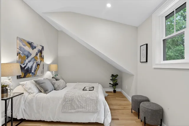 a bedroom with furniture and a window