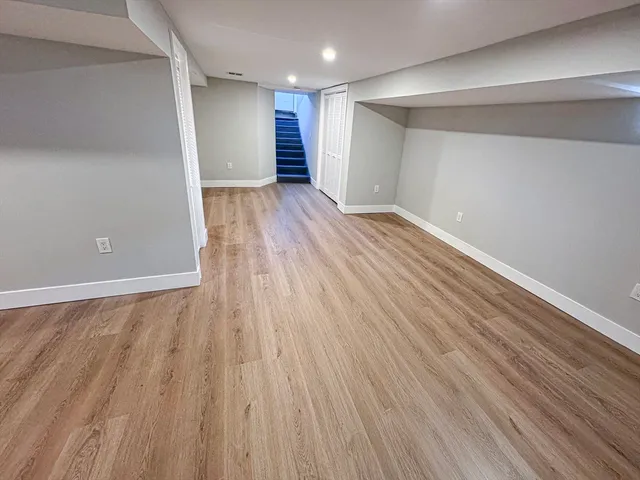 a view of an empty room with wooden floor