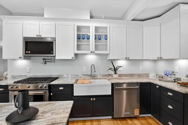 a kitchen with a sink appliances and cabinets
