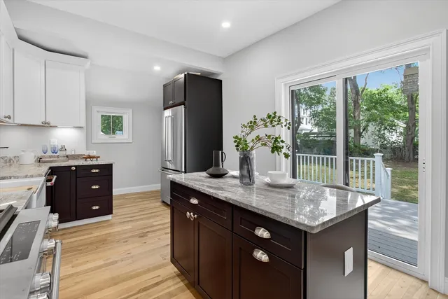 a kitchen with stainless steel appliances granite countertop a refrigerator and a stove top oven