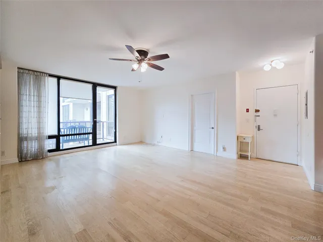 a view of a kitchen with a sink and a refrigerator