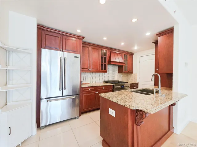 a bathroom with a granite countertop toilet and a sink