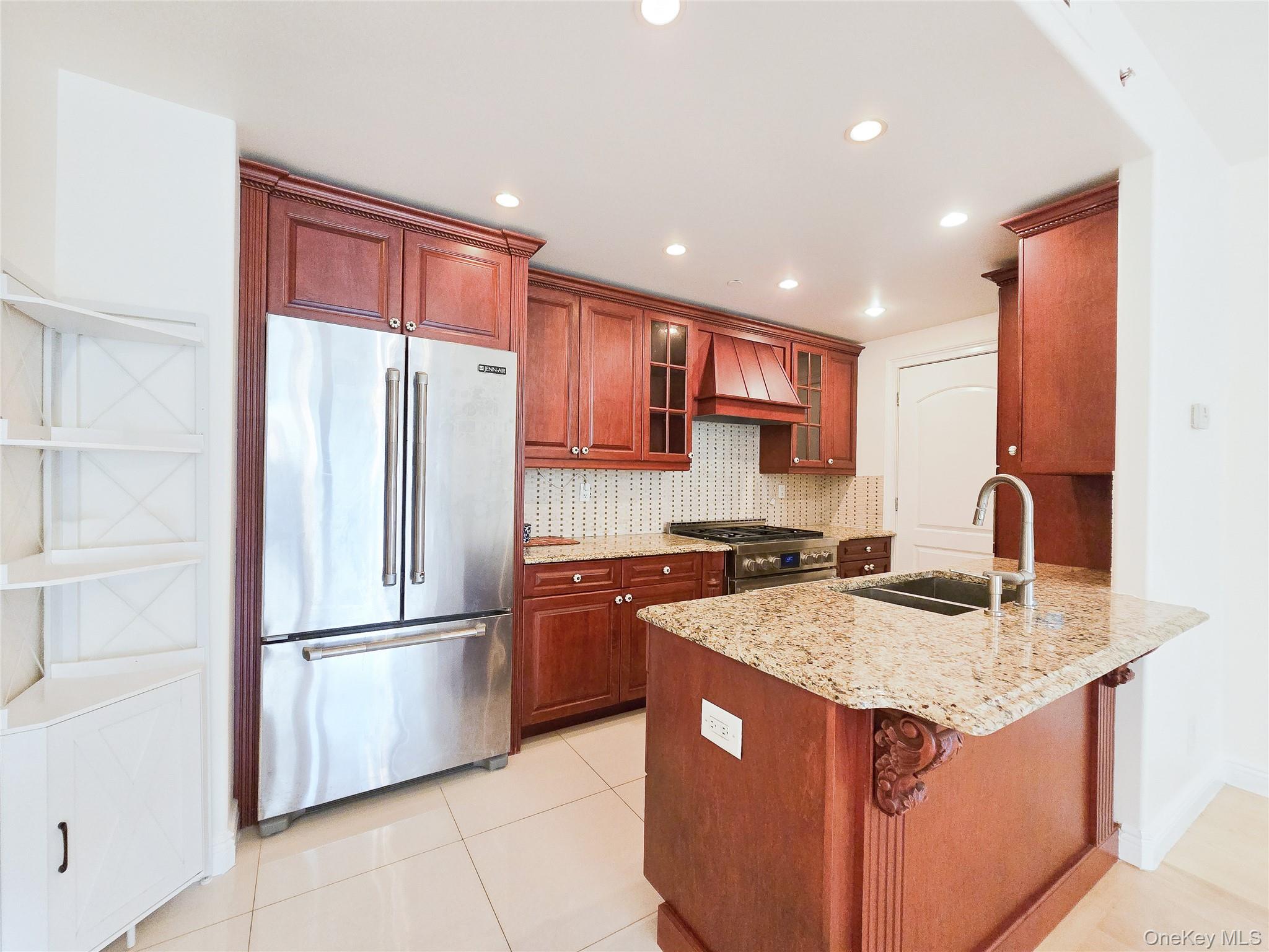 63-36 99th Street, Unit 5B Queens, NY 11374 - Photo 18 of 20 a kitchen with stainless steel appliances granite countertop a refrigerator a sink and a stove