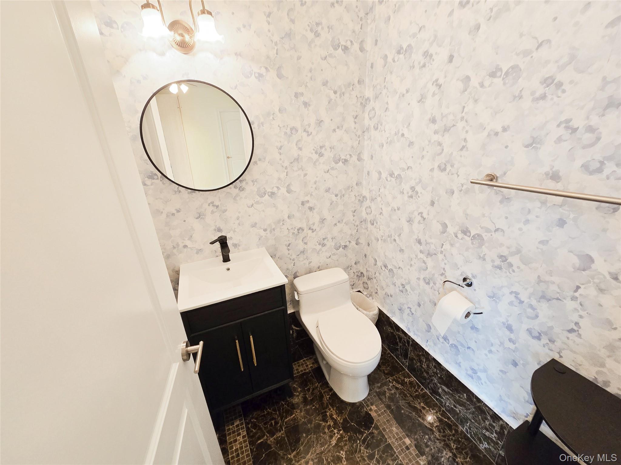 63-36 99th Street, Unit 5B Queens, NY 11374 - Photo 19 of 20 a bathroom with a granite countertop toilet and a sink
