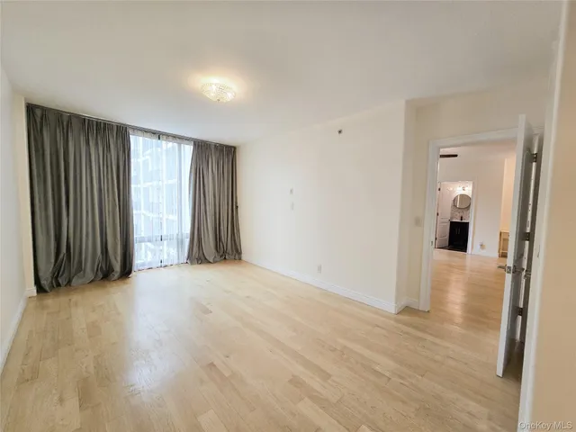 a view of an empty room and wooden floor