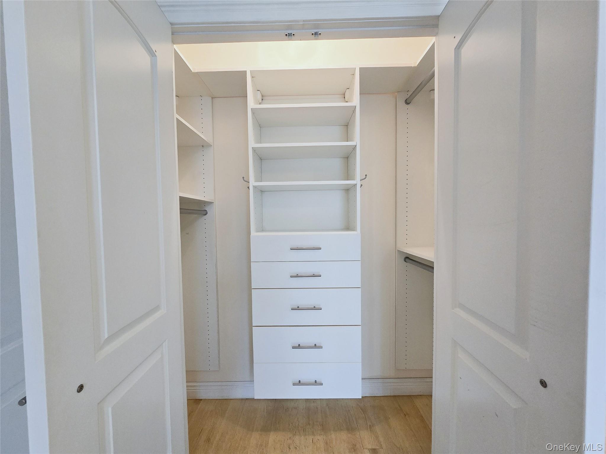63-36 99th Street, Unit 5B Queens, NY 11374 - Photo 8 of 20 a view of walk in closet with empty racks